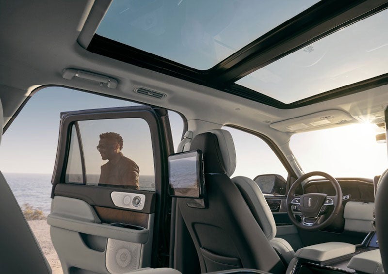 A man is shown opening the second-row door of a 2023 Lincoln Navigator SUV. | Gary Yeomans Lincoln Ocala in Ocala FL