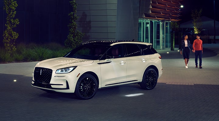 Two people approach a 2024 Lincoln Corsair® SUV featuring the available Jet Appearance Package. | Gary Yeomans Lincoln Ocala in Ocala FL