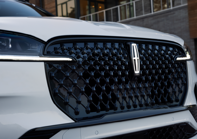 The black grille of a white 2025 Lincoln Aviator® SUV is shown with its fog lights on. | Gary Yeomans Lincoln Ocala in Ocala FL