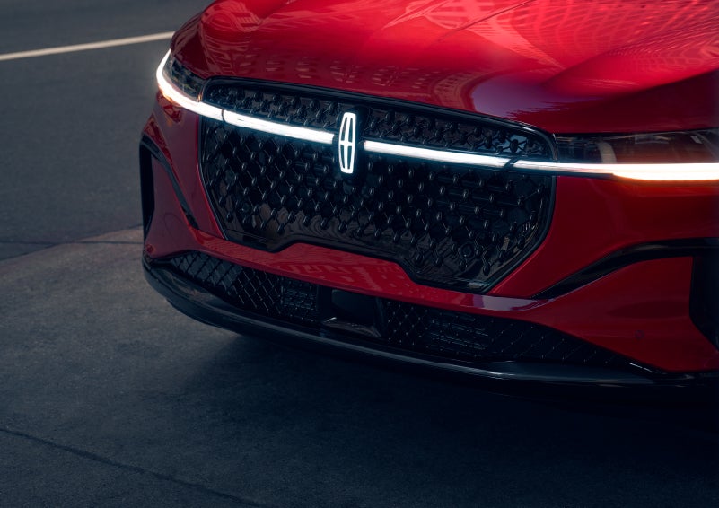 The available front LED light bar and center Lincoln Star logo glow at dusk. | Gary Yeomans Lincoln Ocala in Ocala FL