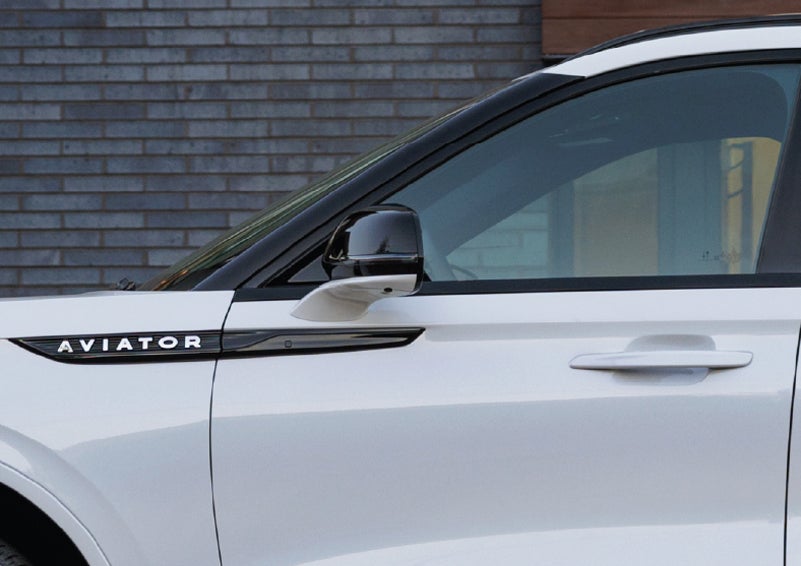 The driver’s side door and fender badging of a white 2026 Lincoln Aviator® SUV are showcased. | Gary Yeomans Lincoln Ocala in Ocala FL