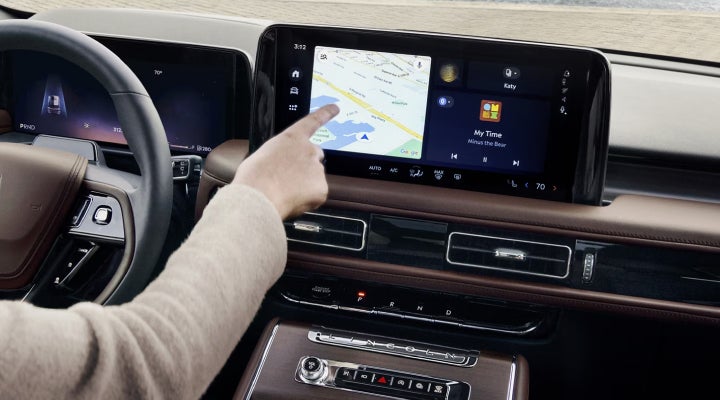 A person is tapping the center display touchscreen of a 2026 Lincoln Aviator® SUV. | Gary Yeomans Lincoln Ocala in Ocala FL