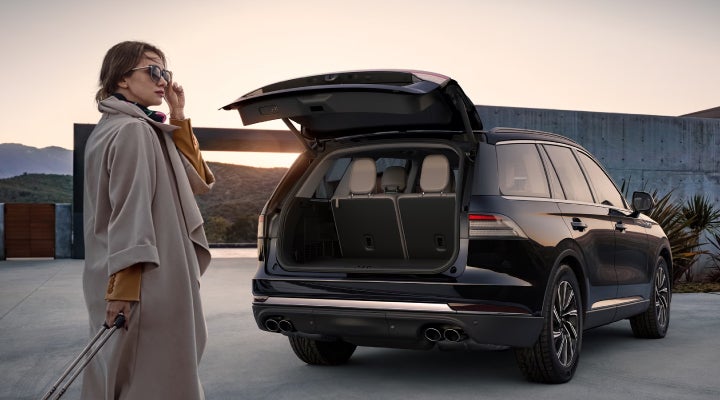 A woman approaches a 2026 Lincoln Aviator® SUV with its rear liftgate open. | Gary Yeomans Lincoln Ocala in Ocala FL