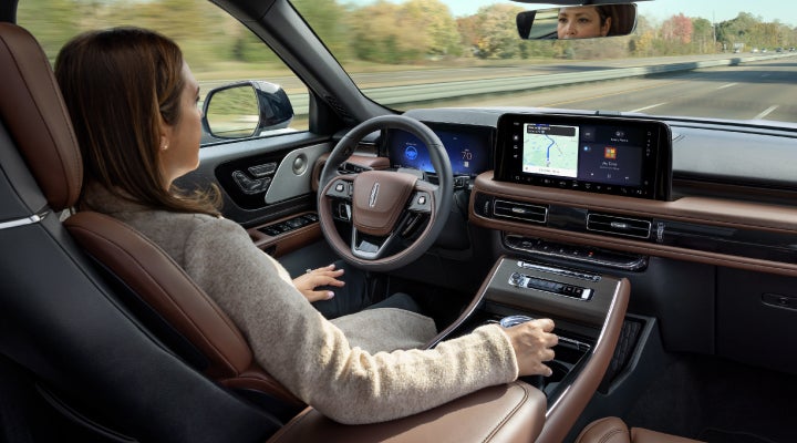 A 2026 Lincoln Aviator® SUV is being driven hands-free on a highway near a forest | Gary Yeomans Lincoln Ocala in Ocala FL