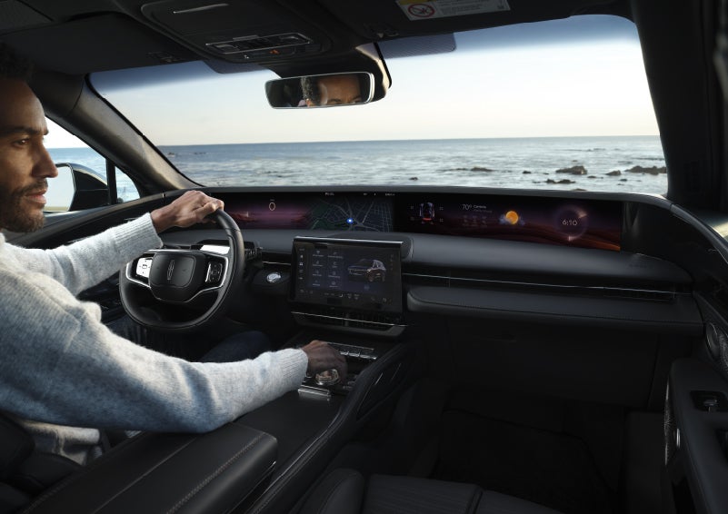 A driver of a parked 2026 Lincoln Nautilus® SUV takes a relaxing moment at a seaside overlook while inside his Nautilus. | Gary Yeomans Lincoln Ocala in Ocala FL