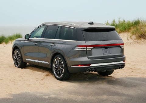 A 2027 Lincoln Aviator® SUV is parked next to sand dunes. | Gary Yeomans Lincoln Ocala in Ocala FL