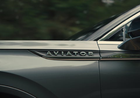 The driver’s side door and fender badging of a gray 2027 Lincoln Aviator® SUV are showcased. | Gary Yeomans Lincoln Ocala in Ocala FL