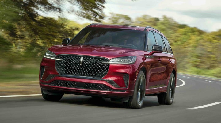 A 2027 Lincoln Aviator® SUV is being driven on a country road | Gary Yeomans Lincoln Ocala in Ocala FL