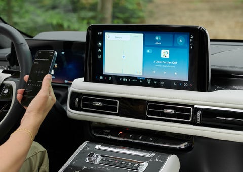 A person pairs thier phone with the center touchscreen of a 2027 Lincoln Aviator® Black Label™ SUV | Gary Yeomans Lincoln Ocala in Ocala FL
